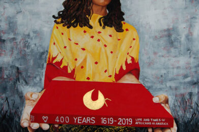 Woman holding 400 years commemorative book.