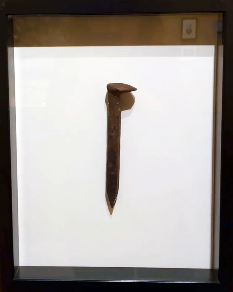 A railroad spike from the transcontinental railroad in a display case