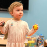 Little girl holding blocks