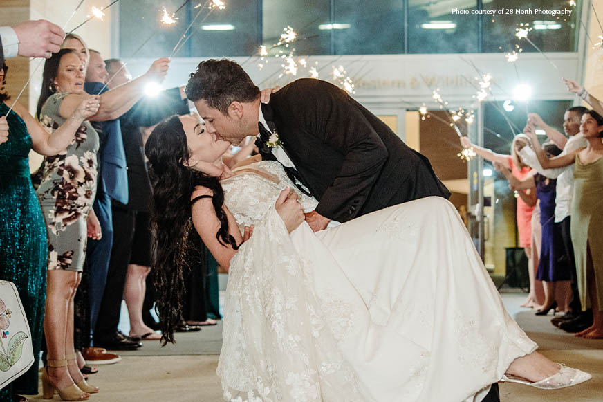 Wedding couple kissing outside of The James museum