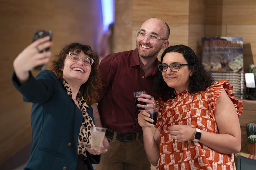 Two women and one man enjoying taking a selfie