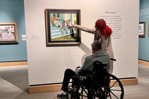 Two people viewing art in a gallery.