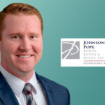 Man in suit with law firm logo.