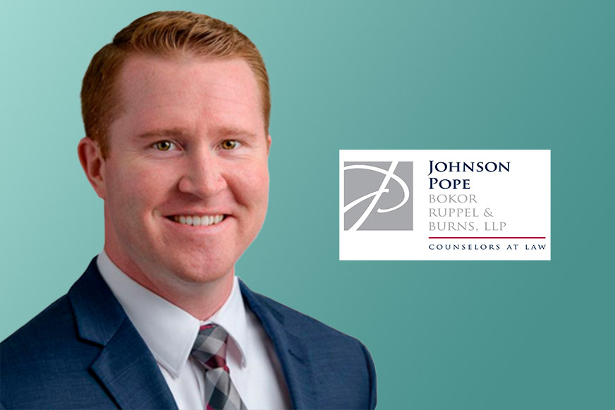 Man in suit with law firm logo.