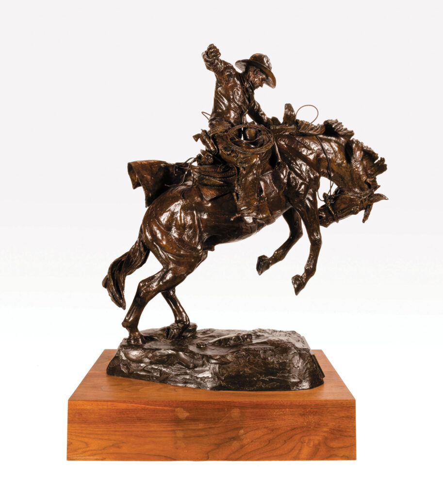 Bronze sculpture of a cowboy riding a bucking horse, mounted on a wooden base, showcased by Frontier Gallery against a plain white background.