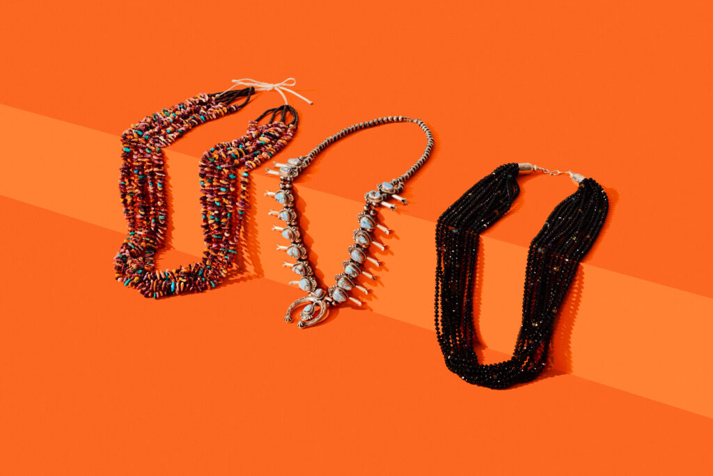 Three beaded and silver necklaces by Indigenous artists on a plain background.