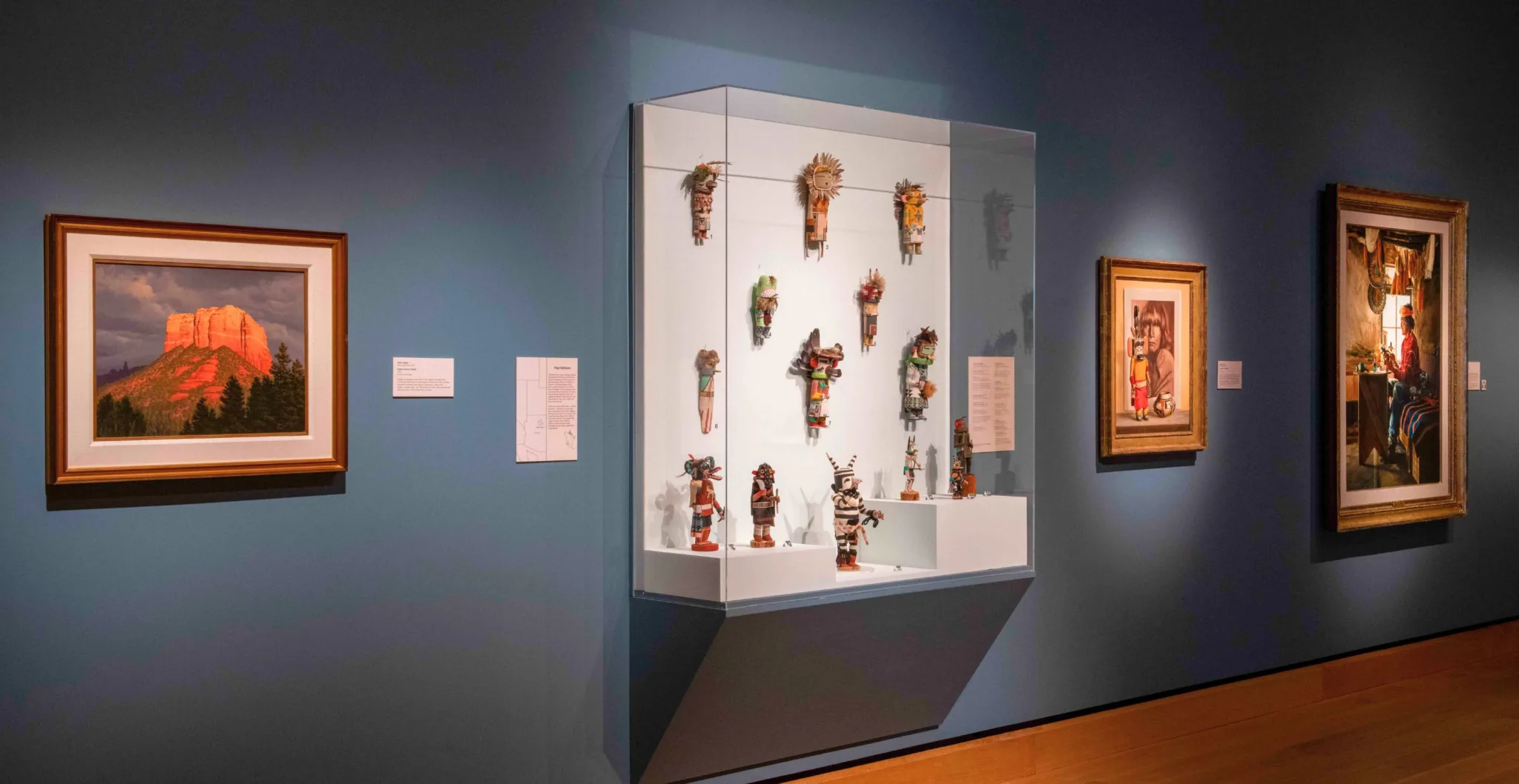 A side view of a clear display case showing several katsina dolls in the Native Life gallery.